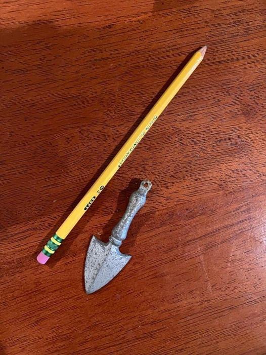 I found an old, finger-sized thing in an old house; does anyone know what it might be? Almost looks like a tiny shovel